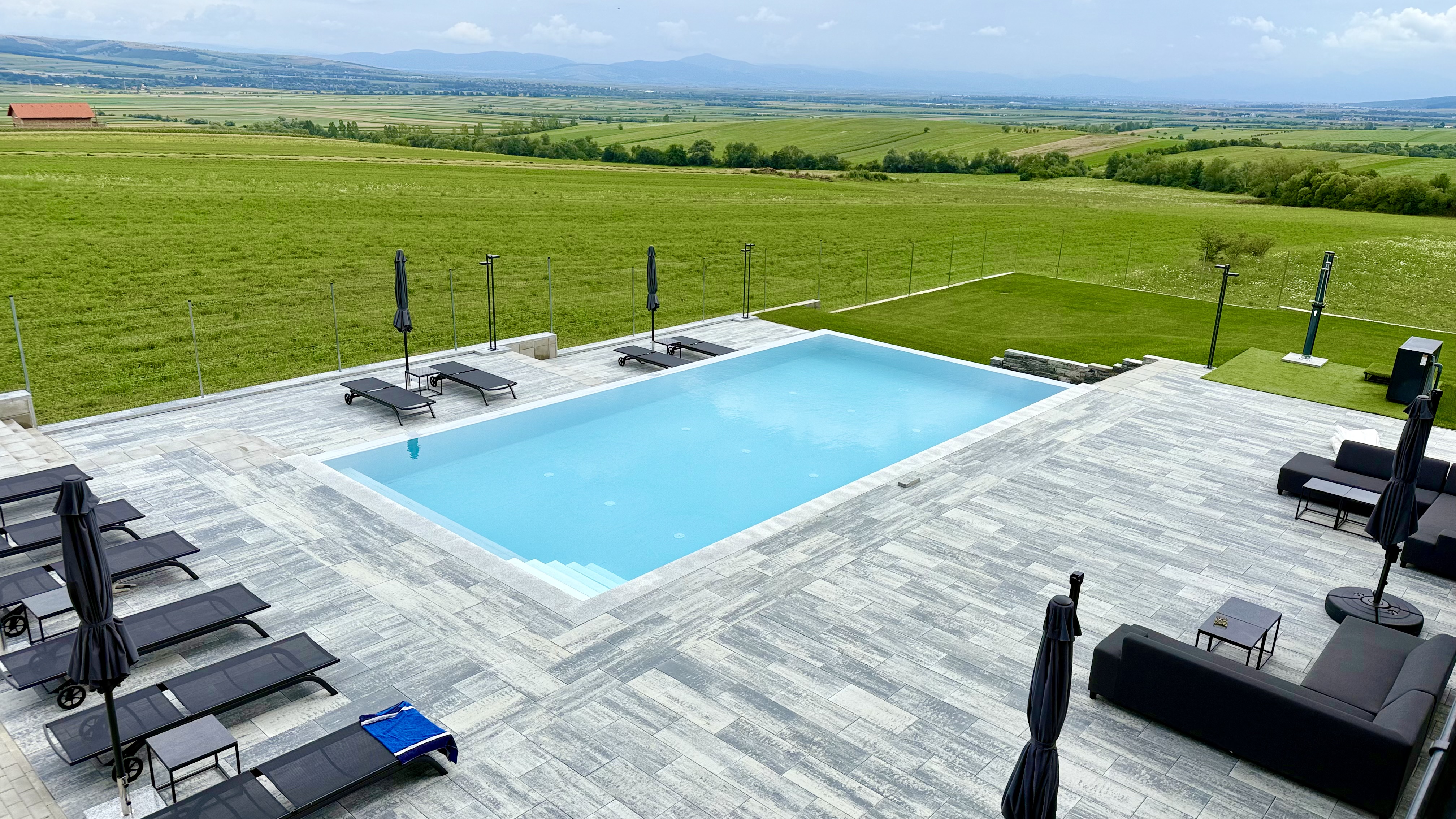 Outdoor pool with panoramic Transylvanian landscape views